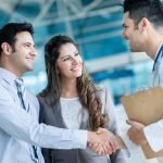 Family doctor handshaking a couple at the hospital